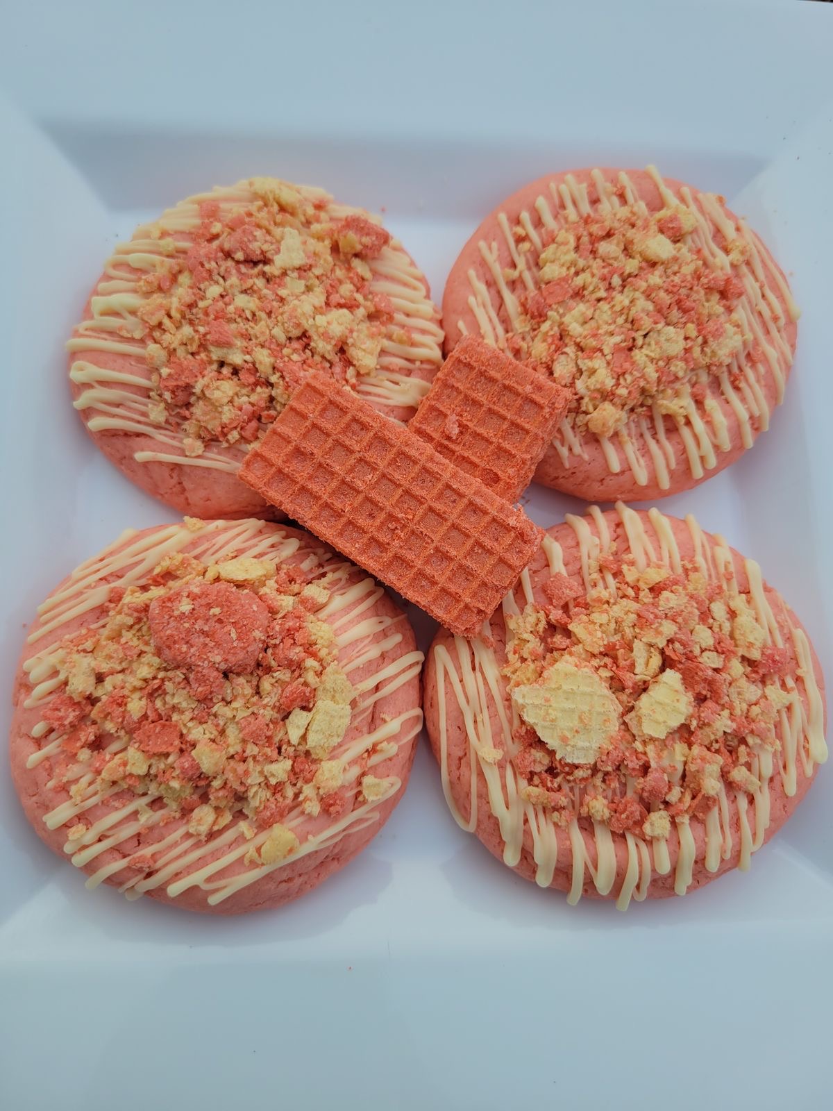 Freshly baked gourmet cookies on a white plate